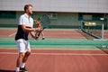 Young man in sportwear is playing tennis on out door court.