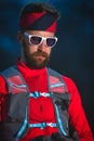 Young man with sporty beard with glasses and long distance running equipment