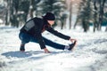 Young man in sporty wear alone doing exercise before running Royalty Free Stock Photo