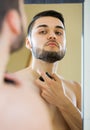 Young man spraying fragrance perfume Royalty Free Stock Photo