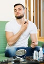 Young man spraying fragrance perfume Royalty Free Stock Photo