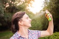 Young man spraying mosquito insect repellent in the forrest, protection. A man sprays mosquito spray on his face Royalty Free Stock Photo