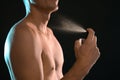 Young man spraying perfume Royalty Free Stock Photo