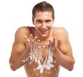 Young man spraying water on his face after shaving in the bathroom Royalty Free Stock Photo