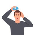 Young man sprinkle hair growth products on his head Royalty Free Stock Photo