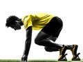 Young man sprinter runner in starting blocks silhouette Royalty Free Stock Photo