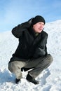 Young man of squatting remedies cap Royalty Free Stock Photo