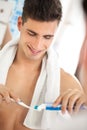 Young man squeezes toothpaste on the brush Royalty Free Stock Photo