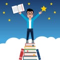 Young man on a stack of books reaching out for the star. StudentÃ¢â¬â¢s hopes and aspirations inspired by reading and education. Royalty Free Stock Photo