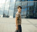 Young man stand in front of modern business building Royalty Free Stock Photo