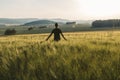 Young man stand in rural czech landscape with wheat field, hill and trees at sunset Royalty Free Stock Photo