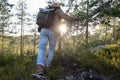 Young man standing alone outdoor with wild forest on background. Royalty Free Stock Photo