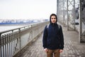 A young man standing on the bridge in the spring Royalty Free Stock Photo