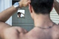 Young Man Standing in Doorway of Rustic Beach Hut Royalty Free Stock Photo