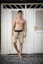 Young Man Standing in Doorway of Rustic Beach Hut Royalty Free Stock Photo