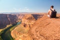 Young man standing at the edge of the Horse Shoe Bend cliff Royalty Free Stock Photo