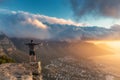 Young man standing on the edge at the top of Lion`s head mountain in Cape Town Royalty Free Stock Photo