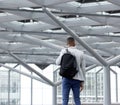 Young man standing in empty airport