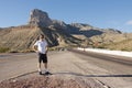 Young man standing in front of Guadalupe Peak, El Capitan from off of highway 62