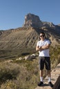 Young man standing in front of Guadalupe Peak, El Capitan in West Texas