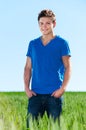 Young man standing in green field Royalty Free Stock Photo