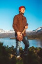 Young man is standing with a guitar on background of mountains and lake. Place for text or advertising Royalty Free Stock Photo