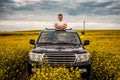 Young man standing in the hatch of a car Royalty Free Stock Photo