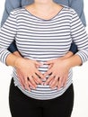 Young man standing with his pregnant woman hands together in belly Royalty Free Stock Photo