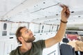 Man puts noise insulation on the inside of a van