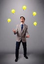 Young man standing and juggling with light bulbs Royalty Free Stock Photo