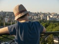 Young man standing looking on Modern skyscrapers in business district in evening light at sunset Royalty Free Stock Photo