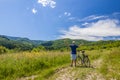 Young man standing near bicycle in morning sunrise with wonderf Royalty Free Stock Photo