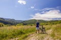 Young man standing near bicycle in morning sunrise with wonderf Royalty Free Stock Photo