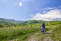 Young man standing near bicycle in morning sunrise with wonderf Royalty Free Stock Photo