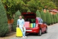 Young man standing near car trunk loaded Royalty Free Stock Photo