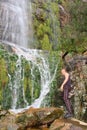 Young man standing next to waterfall Royalty Free Stock Photo