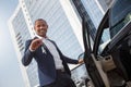 Young man standing opening car door holding keys looking camera cheerful bottom view Royalty Free Stock Photo