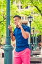 Young man standing outdoors, talking on cell phone in New York City Royalty Free Stock Photo