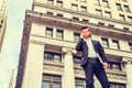 Young man standing outside office building in New York City, talking on cell phone Royalty Free Stock Photo