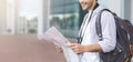 Young man standing with paper man at airport Royalty Free Stock Photo