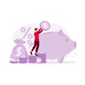 The young man is standing on a pile of coins and putting coins in a giant piggy bank. Concept of saving money.