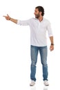 Young Man Is Standing, Pointing At Te Side And Talking Royalty Free Stock Photo