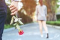 Young man standing with a Red Rose on Hand Sadness Love in Ending Break up Royalty Free Stock Photo