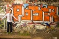 Young Man Standing by Sign