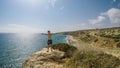 Cyprus - Young man standing at the edge of a cliff with his arms wide open Royalty Free Stock Photo