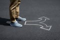 Young man standing on a street with arrow signs pointing in different directions concept for life choices Royalty Free Stock Photo