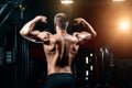 Young Man Standing Strong In The Gym And Flexing Muscles - Muscular Athletic Bodybuilder Fitness Model Posing After Exercises Royalty Free Stock Photo