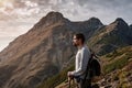 Young man standing on top of cliff mountains Royalty Free Stock Photo