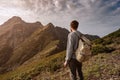 Young man standing on top of cliff mountains Royalty Free Stock Photo