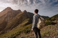 Young man standing on top of cliff mountains Royalty Free Stock Photo